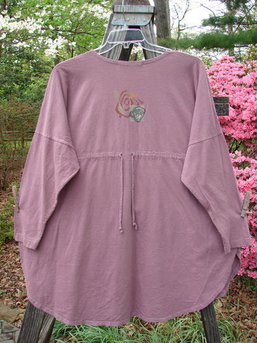1996 Long Sleeved Pop Top Tea Time Laurel OSFA displayed on a clothes rack, featuring a scooped rolled neckline, drop shoulders, oversized exterior front pocket with textured button, and a rear drawcord back.