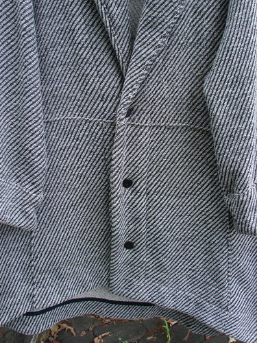 Barclay Patched Wool City Side Big Pocket Coat features a black and white stripe herringbone design with a stand-up collar, sectional panels, triple button closure, and deep front pockets, offering an elegant A-line flair.