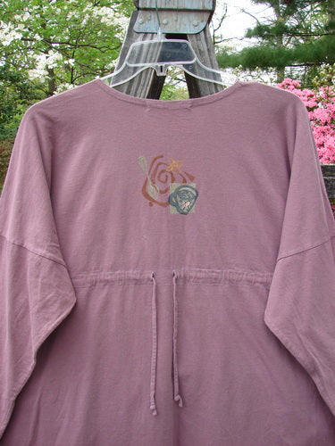 1996 Long Sleeved Pop Top Tea Time Laurel OSFA displayed on a swing, featuring a rounded hemline, scooped rolled neckline, drop shoulders, oversized front pocket with button, and rear drawcord back.