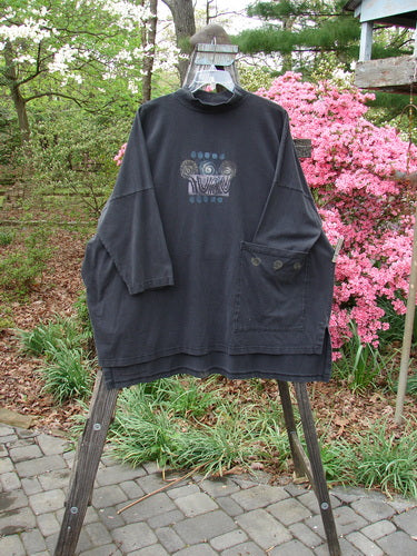 1996 Message Top Turn Path Black Size 3 displayed on a hanger, featuring a ribbed mock turtleneck, oversized front pocket, abstract paint design, drop shoulders, and Blue Fish signature patch.