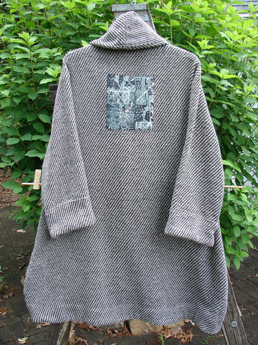 Barclay Patched Wool City Side Big Pocket Coat features a stand-up collar, sectional panels, triple button closure, and deep front pockets, crafted in a black and white stripe herringbone wool blend.