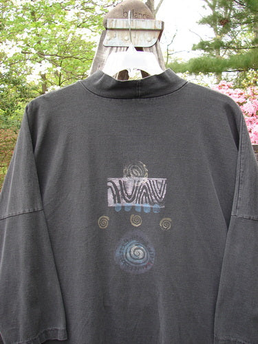 1996 Message Top Turn Path Black Size 3 featuring abstract spiral design, ribbed mock turtleneck, oversized front pocket, drop shoulders, and a unique varying hemline.