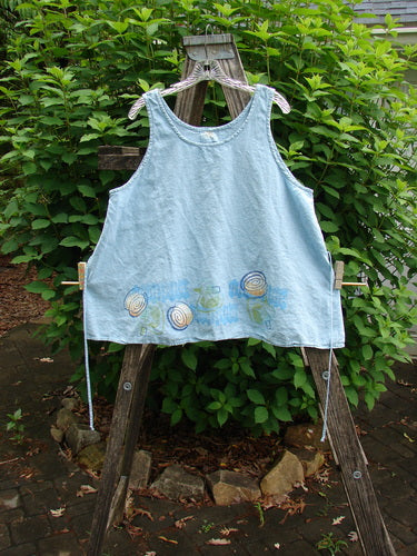 2000 Hemp Flared Tank Tumble Blue Jet Size 2 features a flared A-line shape, feminine scooped neckline, bright hemline paint in a tumble path theme, and adjustable tie string for customization.