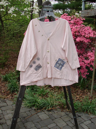 1996 Triangle Cardigan Travel Blue Fish Birch Bark OSFA displayed on a rack, highlighting its deep V-neckline, varying hemline, angled front pockets, and original buttons with a signature Blue Fish stamp.