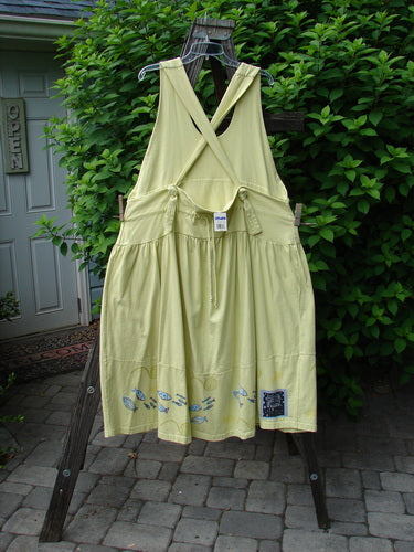 1999 NWT Tadpole Jumper Single Stripe Pike School Citron OSFA: Yellow dress with adjustable shoulder straps, sweeping hemline, criss-cross back, and fish-themed hem, displayed on a clothesline.
