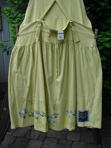 1999 NWT Tadpole Jumper Single Stripe Pike School Citron OSFA features a yellow skirt with fish motifs, adjustable shoulder straps, and two round pockets, showcasing a whimsical design from BlueFishFinder.com.