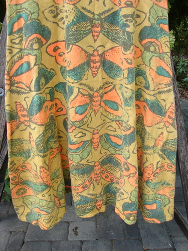 Magnolia Pearl NWT Cotton Fleece Lepidoptera Lana Tank Dress Butterfly Sunnies OSFA draped on a chair, showcasing its butterfly motif and pleated design.