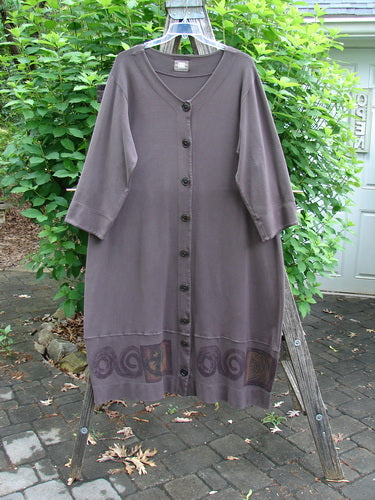 2000 Interlock Glassgow Coat Dress in Peat, featuring oversized buttons, painted bottom panel, and Celtic theme. Designed for generous movement with wide hem and double stitching, echoing Bluefishfinder's vintage style.