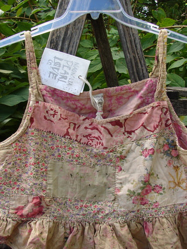 Magnolia Pearl NWT Quilted Catalina Tank Ragdoll Calico OSFA hanging outdoors, showcasing its vintage-inspired cotton panels, ruffled hem, and hand-mending details, embodying creative freedom and individuality from Bluefishfinder.com.