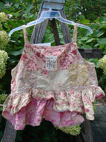 Magnolia Pearl NWT Quilted Catalina Tank Ragdoll Calico OSFA, a bohemian-style crop top with patchwork design, features a ruffled hem, embroidery, and quilting, displayed on a wooden ladder.