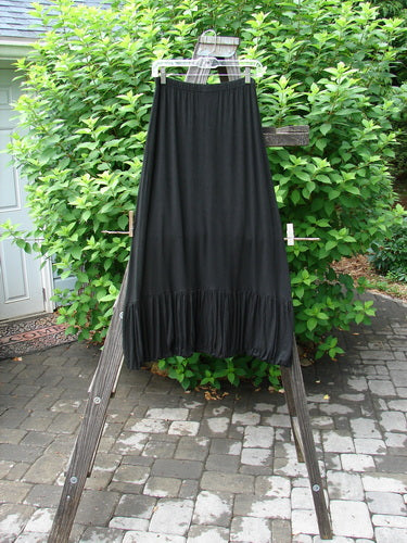 2000 Rayon Lycra Bubble Skirt Unpainted Black Size 1 displayed on a wooden ladder, showcasing its super gathered bubble bottom and tapered elastic hemline.