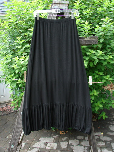 2000 Rayon Lycra Bubble Skirt Unpainted Black Size 1 displayed on a clothes rack, showcasing its super gathered bubble bottom, straighter stretch cut, and tapered elastic hemline.