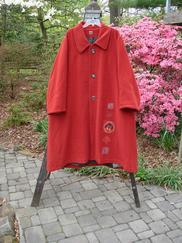1999 Patched Woven Overcoat Tomato Altered Size 0 displayed on a rack, highlighting its vintage oversized button front, hand-blocked patches, and deep inseam wool-lined pockets.