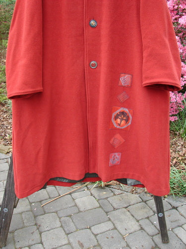 1999 Patched Woven Overcoat Tomato Altered Size 0, featuring hand-blocked patches, three oversized buttons, deep inseam pockets, and a vintage-inspired A-line shape with foldable lower sleeves.