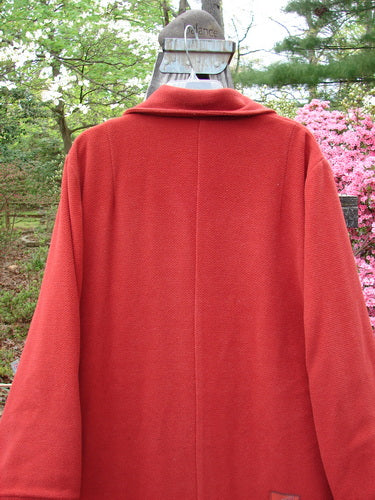 1999 Patched Woven Overcoat Tomato Altered Size 0 displayed on a metal rack, showcasing vintage oversized buttons, hand-blocked patches, and deep inseam wool-lined pockets.