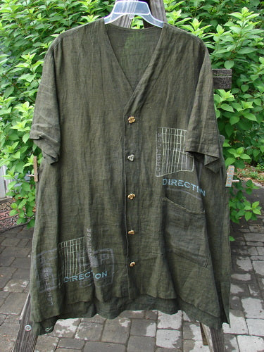 2000 Cross Dye Linen Downtown Jacket Directional Oregano Size 2 displayed on a hanger, featuring ceramic glazed buttons, a V-shaped neckline, A-line shape, and a single oversized exterior pocket.