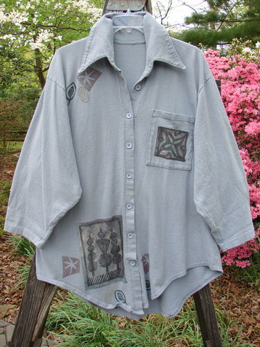 1994 Reprocessed Work Shirt Topiary Moon Solstice Blue OSFA featuring a painted breast pocket, pointed collar, deep drop shoulders, and Blue Fish patch, worn by a person outdoors.