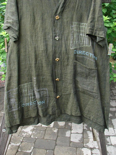 2000 Cross Dye Linen Downtown Jacket Directional Oregano Size 2, featuring ceramic glazed buttons, A-line shape, V-shaped neckline, and single exterior pocket, hanging on a clothesline.