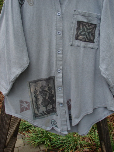 1994 Reprocessed Work Shirt Topiary Moon Solstice Blue OSFA with a painted breast pocket, pointed collar, deep drop shoulders, rounded shirttail, and Blue Fish buttons, showcasing intricate topiary and moon designs.