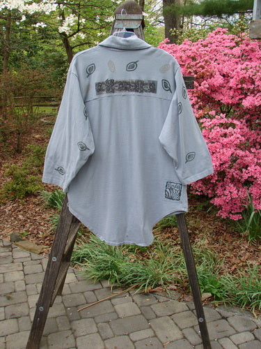 1994 Reprocessed Work Shirt Topiary Moon Solstice Blue OSFA displayed on a wooden stand, showcasing unique features like a painted breast pocket, pointed collar, and double-paneled shoulder seam.