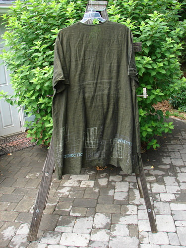 2000 Cross Dye Linen Downtown Jacket Directional Oregano Size 2 displayed on a clothes rack, showcasing its A-line shape, ceramic glazed buttons, and single exterior pocket.