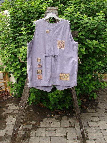 1996 Denim Visionary Vest Travel Stone Stratus Size 1 displayed on a rack, featuring a V-shaped neckline, metal buttons, rivet pockets, rear buckle draw tab, and detailed paint accents.