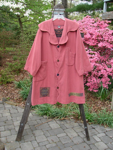 2000 Patched Wool Nora Coat Pastel Geranium Size 0 displayed on a wooden stand features scalloped pockets, playful button lines, brightly painted patches, and oversized vintage buttons.
