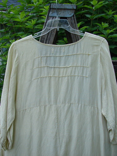 Barclay Hemp Silk Triangular Two Tier Dress Star Wind Citron Size 2, displayed on a swinger, features a V-shaped neckline, pinched accents, and a varying hemline, embodying vintage Blue Fish Clothing's creative expression.