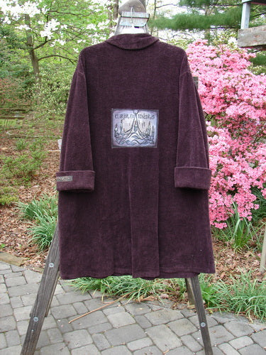 1999 Patched Chenille Angle Pocket Jacket in Deep Burgundy with oversized vintage buttons, angled front pockets, and a large Holiday Gates theme patch displayed on a stand.
