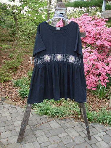 2000 Rosalee Dress Daisy Row Black Size 2 on a rack, featuring a swingy babydoll style, gathered waist seam, and daisy row theme bodice paint.