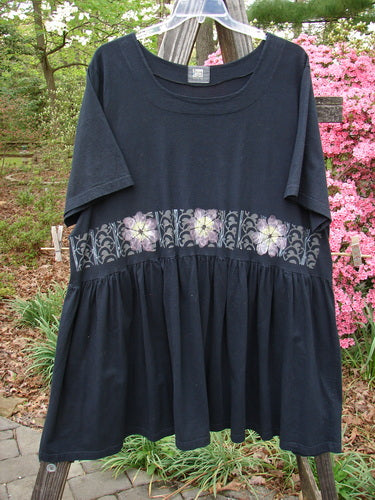 2000 Rosalee Dress Daisy Row Black Size 2, featuring a gathered waistline and sweeping lower hem, adorned with a continuous daisy row theme on the bodice. Perfect condition, organic cotton.