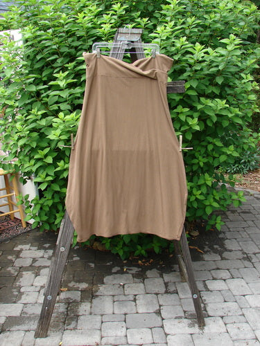 Barclay Cotton Lycra Fold Over Bottom Bell Skirt Unpainted Coco Size 2 displayed on a wooden stand, showcasing the cross-over front banded waistline and lower bell accent.