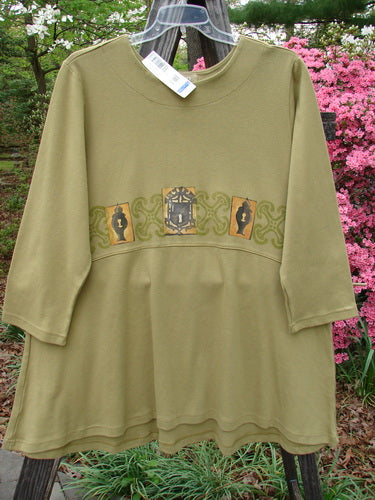 1999 NWT Interlock Scoop Top Celtic Holiday Leaf Size 2, featuring a rounded neckline, downward scooped empire waistline, and drawcord back, displayed on a hanger with a visible white tag.