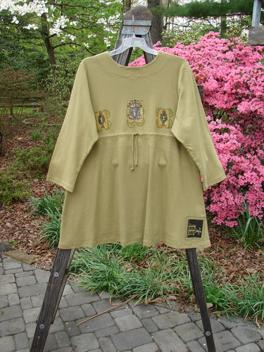 1999 NWT Interlock Scoop Top Celtic Holiday Leaf Size 2 displayed on a hanger, highlighting its rounded neckline, scooped empire waistline, and signature Blue Fish Patch.