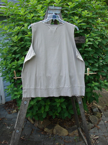 Barclay NWT Flutter Bottom Tank Moon Rock Size 2 displayed on a clothes rack, showcasing its rounded neckline, slight A-line shape, and distinct lower flutter design, embodying Bluefishfinder.com's creative and vintage style.