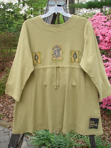 1999 NWT Interlock Scoop Top Celtic Holiday Leaf Size 2 featuring a scooped empire waistline, rounded neckline, drawcord back, and signature Blue Fish patch with a Celtic design.
