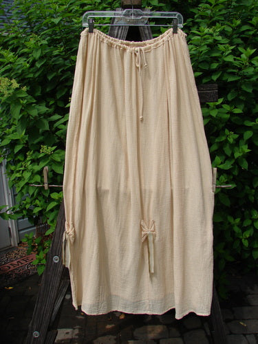 Barclay Gauze Tool Skirt Unpainted Kauiclla Size 2 on clothesline, showcasing full drawcord waistline, vertical tabs with hand-dyed silk ribbon, and gathered fall.