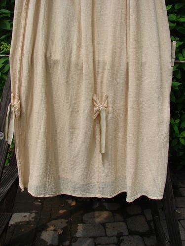 Barclay Gauze Tool Skirt Unpainted Kauiclla Size 2 on a clothesline, showcasing its full drawcord waistline, widening shape, gathered fall, and vertical tabs with hand-dyed silk variegated ribbon accents.