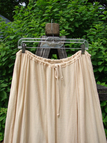 Barclay Gauze Tool Skirt Unpainted Kauiclla Size 2 displayed on a hanger, showcasing its full drawcord waistline, widening shape, and gathered fall with vertical tabs accented in hand-dyed silk ribbon.