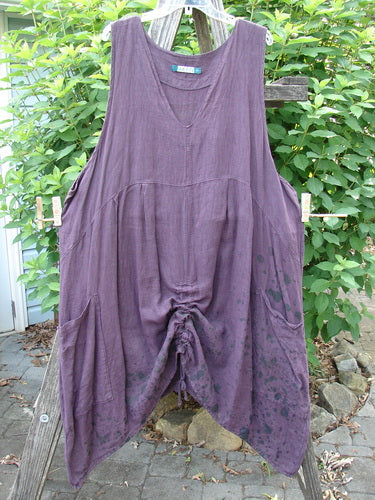 Barclay Linen Two Pocket Pull Up Jumper Berry Vine Red Plum Size 2: A gracefully draped jumper with a softly dipped V neckline, vertical seams, and dual pleats, showcasing a feminine A-line shape.