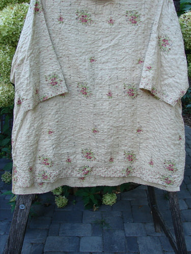 Magnolia Pearl European Cotton Quilted Hi Low Frances Top Vintage Rose OSFA, featuring a loose fit, quilted texture, floral pattern, high-low hemline, and drop dolman sleeves, draped over a ladder outdoors.
