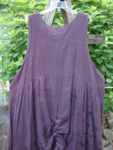 Barclay Linen Two Pocket Pull Up Jumper Berry Vine Red Plum Size 2 displayed outdoors, highlighting its feminine shape, softly dipped V neckline, and dual pleats, reflecting BlueFishFinder's vintage style.