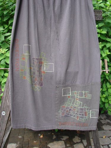 2000 Block Skirt Directional Iron Size 2, featuring a unique map design, organic cotton fabric, and a professionally replaced larger elastic waistband, displayed on a wooden board.