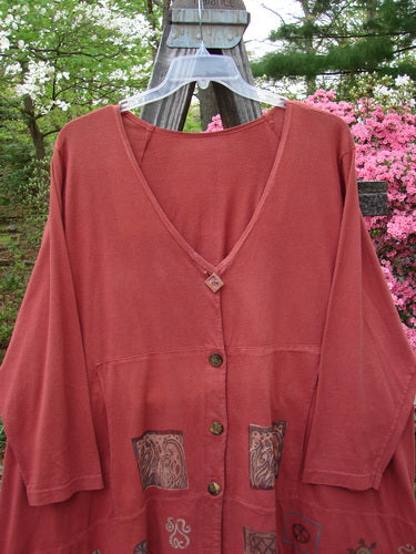 1993 Modernismo Cardigan Growth Woodberry Altered OSFA displayed on a hanger, showcasing its classic A-line design, oversized patch, and unique button details against a natural outdoor setting.