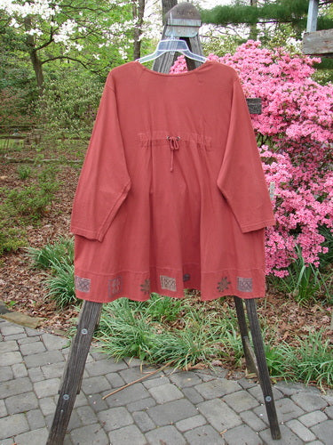 1993 Modernismo Cardigan Growth Woodberry Altered OSFA displayed on a hanger, showcasing its A-line swing, old-time buttons, kangaroo tunnels, drawcord back, oversized patch, and thicker banded hemline.