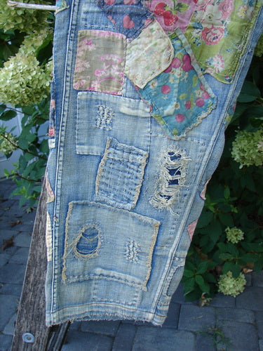 Magnolia Pearl NWT Denim Heavily Patched Miner Jean Garden Patch Washed Indigo OSFA features vibrant fabric patches and intricate hand-stitching, draped outdoors, reflecting Bluefishfinder.com's vintage and creative aesthetic.