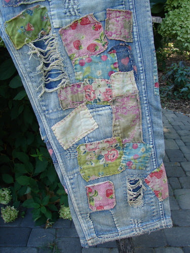 Magnolia Pearl NWT Denim Heavily Patched Miner Jean Garden Patch Washed Indigo OSFA features floral-printed fabric patches on light-washed denim, showcasing frayed edges and intricate stitchery.