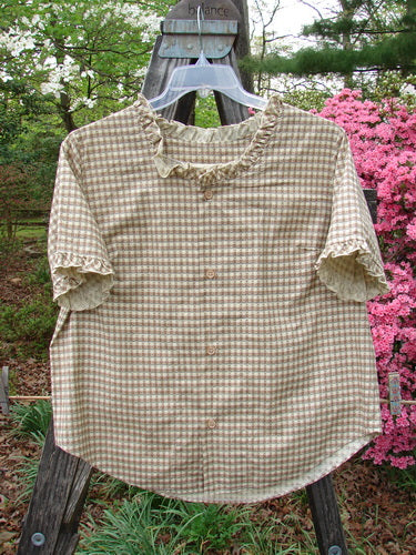 1996 Woven Boardwalk Top Unpainted White Pine Gingham Size 2 displayed on a wooden post, showcasing its gathered ruffle neck, sleeve lines, and rounded hem, embodying vintage Blue Fish style.