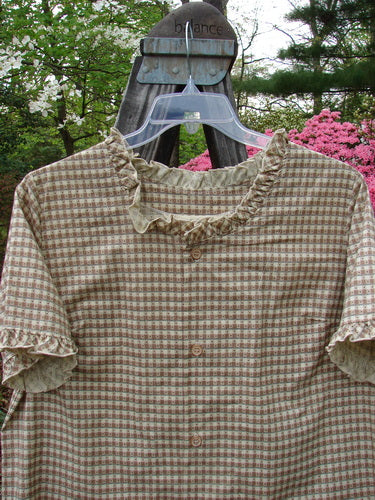 1996 Woven Boardwalk Top in Unpainted White Pine Gingham, displayed on a hanger, featuring gathered ruffle neck and sleeve lines, rounded hem, and bust line darts.