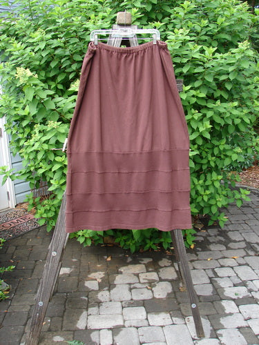 Barclay Interlock Rib Panel Skirt Unpainted Sepia Size 2 displayed on a wooden stand, showcasing horizontal ribbed panels and smooth cotton knitting with exterior stitchery.